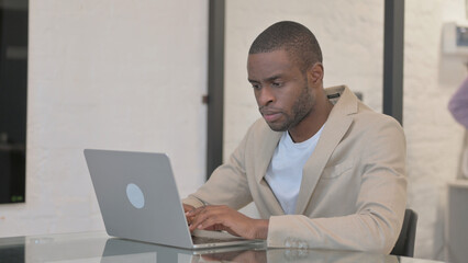 Fototapeta premium African American Man Working on Laptop