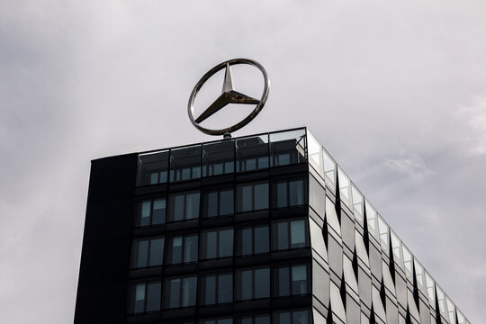 Berlin, Germany - April 1 , 2024: Rotating Mercedes logo on the roof of an office building.