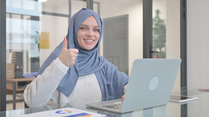 Thumb Up by Woman in Hijab while Working on Laptop