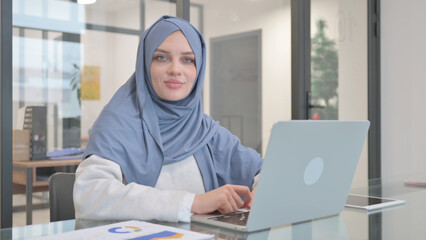 Woman in Hijab Shaking Head in Denial while Working on Laptop