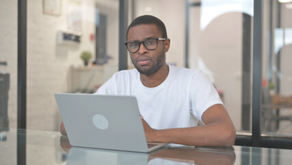 Serious African American Man Looking at Camera in Office