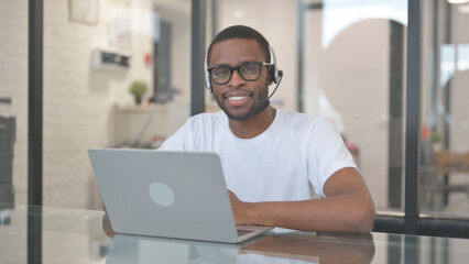 Smiling African American Man with Headset in Call Center