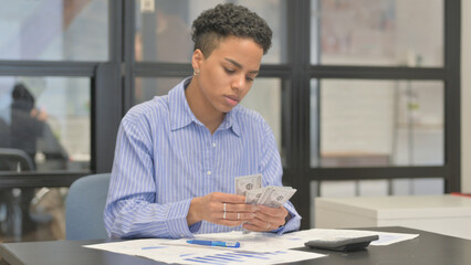 Mixed Race Woman Doing Financial Calculations and Paperwork