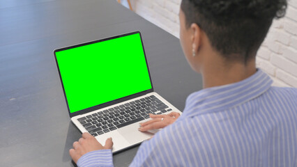 African Woman Using Laptop with Chroma Key Screen