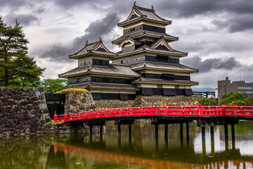 Ancient Matsumoto Castle in Nagano, Japan on a stormy spring day - obrazy, fototapety, plakaty