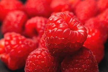 Close-up of fresh delicious raspberries in macro photography. Delicious berries vitamins and healthy food