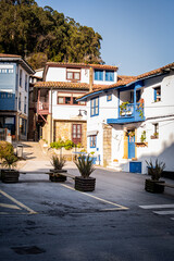 Vibrant town square in Lastres, Asturias, surrounded by colorful stone and wood houses.