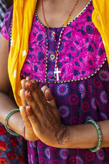 Christian adivasi woman joining hands in a village in Narmada district, Gujarat, India
