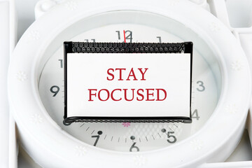 Motivation concept. STAY FOCUSED written on a white business card