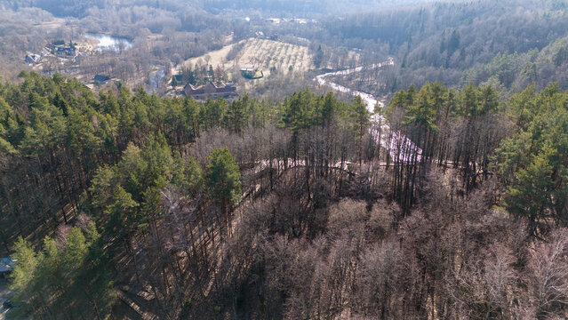 Drone photography or rural landscape and a few houses near a river during spring day