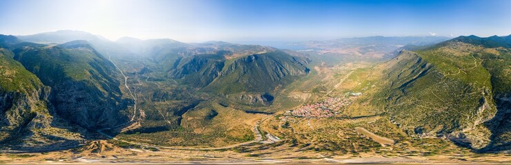 Delphi, Greece. Ruins of the ancient city of Delphi and the modern city. View of the valley. Sunny...