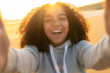 Happy Smiling Biracial African American Girl Teenager Selfie on Beach at Sunset