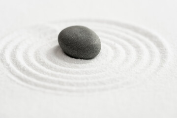 Fototapeta na wymiar Zen Garden with Grey Stone on White Sand Line Texture Background, Top View Black Rock Sea Stone on Sand Wave Parallel Lines Pattern in Japanese stye, Simplicity Day, Meditation,Zen like concept