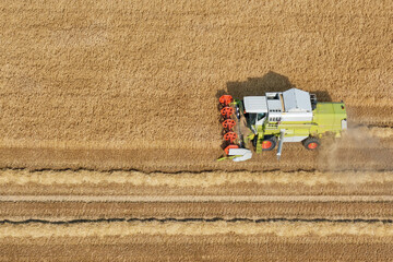 Aerial view of combine harvester working on a field. Copy space.