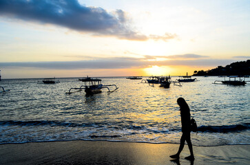 The view of the sunset with a very beautiful sky and boats leaning on Senggigi Beach