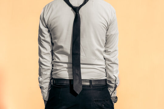 businessman in white shirt with black pent on peach color background