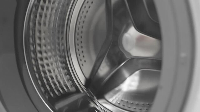washing machine empty drum rotates and stops, selective focus, slow motion
