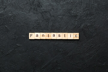 fantastic word written on wood block. fantastic text on cement table for your desing, concept