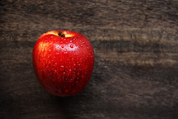 Red apple on a wooden board