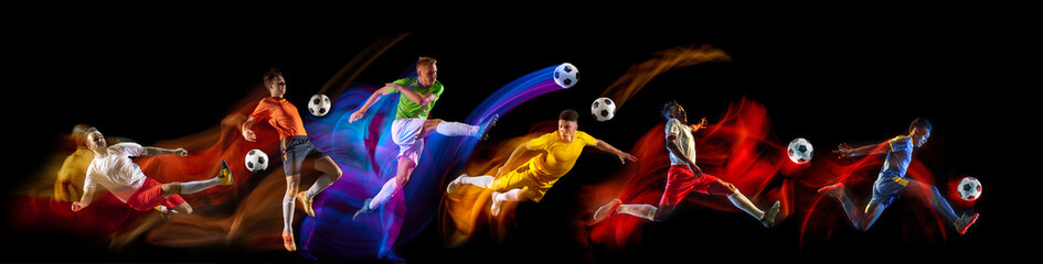 Male football players in motion with ball, playing on black background in neon with mixed lights....