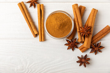 Ceylon cinnamon sticks and anise on a textured wooden background.Cinnamon roll and star anise. Spicy spice for baking, desserts and drinks. Fragrant ground cinnamon.Place for text. copy space.
