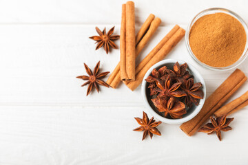 Ceylon cinnamon sticks and anise on a textured wooden background.Cinnamon roll and star anise....