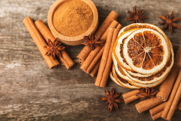 Ceylon cinnamon sticks and anise on a textured wooden background.Cinnamon roll and star anise. Spicy spice for baking, desserts and drinks. Fragrant ground cinnamon.Place for text. copy space.