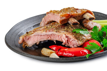 grilled pork ribs on a plate with celery and vegetables on a white background