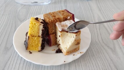 Man eating cake with a spoon