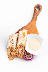 Doner kebab with chicken is a dish of grilled chicken and fresh vegetables wrapped in pita bread on...