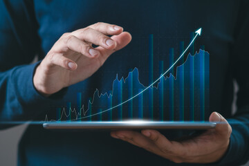 BusinessMan hand using tablet checking stock market graph report via mobile app. finance and...