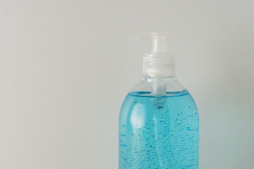 Hand sanitizer in a bottle on a bright background. Coronavirus prevention concept.