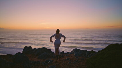 Sensual woman silhouette dancing sunset ocean landscape at summer. Girl dance