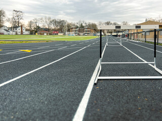 Track and Field Running Lanes. Surface level view of a line of hurdles on a running track. Hurdles...