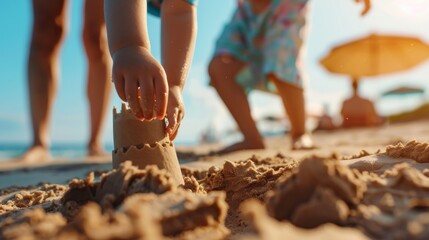 closeup child's hand building a sandcastle