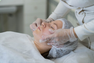 Gentle facial touch-ups after aesthetic procedure. It underscores the personalized attention in modern cosmetic services.