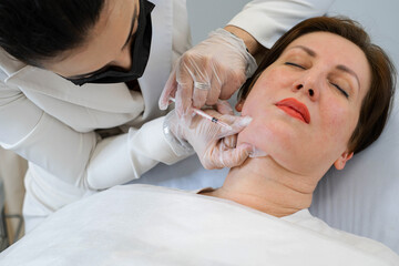 Targeted double chin treatment with lipolytics, patient hopeful. Connects to the quest for refined facial profiles.