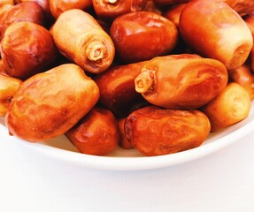 Date-palm fruit golden semi-dried zahedi irani dates in a bowl sweet organic food Iranian datepalms khajoor kurma zahidi phoenix dactylifera closeup view image stock photo