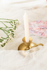 golden candelabra on white tulle and tarot cards