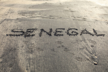 Beach in Ndayane, Senegal. The word Senegal written on sand