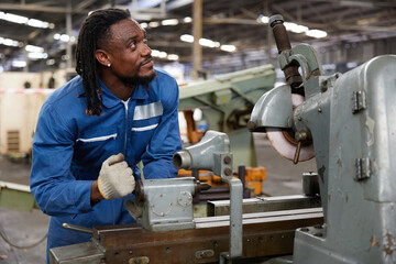 technician or worker checking and control lathe machine in the factory