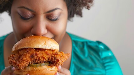 Woman with a fuller figure enjoying a delicious fried chicken burger