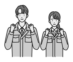 ガッツポーズする作業服姿の男性と女性（上半身）