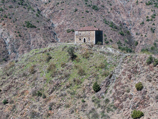 Aerial image of a historical abandoned fortified house build on the top of a rocky hill over 200...