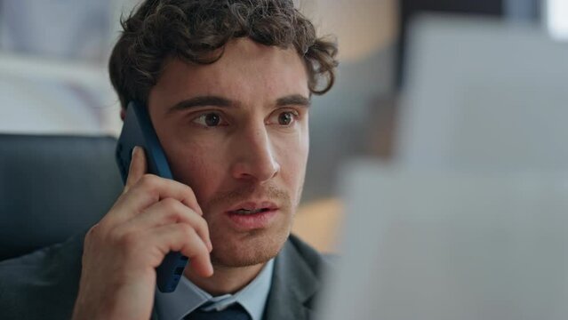 Worried businessman speaking phone checking papers at office closeup. Mad guy