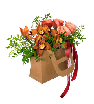 Bouquet of cymbidium orchids in a cardboard box. Isolated