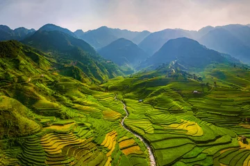Photo sur Plexiglas Mu Cang Chai Aerial top view of paddy rice terraces, green agricultural fields in countryside or rural area of Mu Cang Chai, Yen Bai, mountain hills valley at sunset in Asia, Vietnam. Nature landscape background.