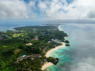 Tropical white sands in beach resorts in Boracay with clear turquoise sea water. Philippines.
