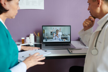 Doctor explaining advantages of new pills to medical specialists during online meeting