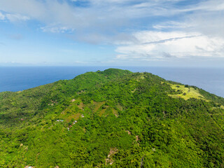 Mountain landscape with green plants and trees in Cobrador Island. Romblon, Philippines.